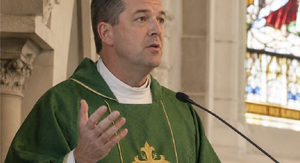 Catholic priest preaching